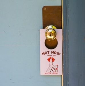 do not disturb sign hanging on doorknob